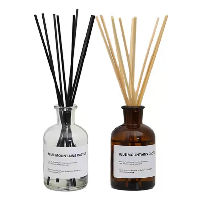 Two reed diffuser bottles with natural rattan reeds
